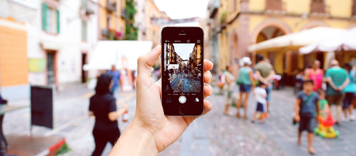 Smartphone in a hand with city background